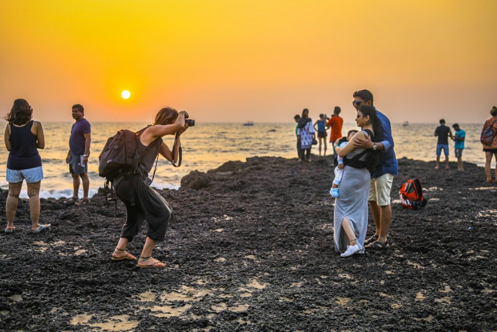 people walking on brown sand during sunset