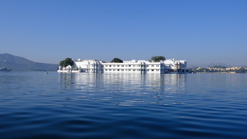 a large white building sitting on top of a lake